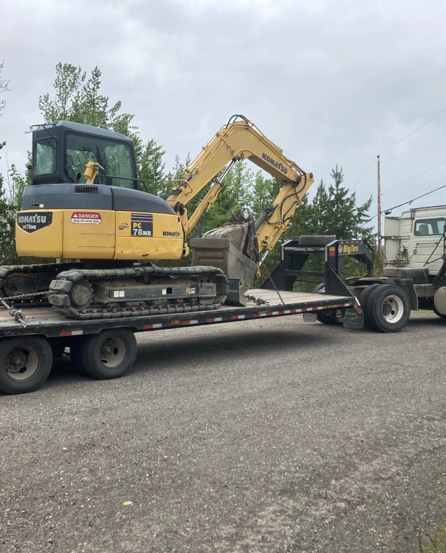 Excavator on heavy equipment trailer