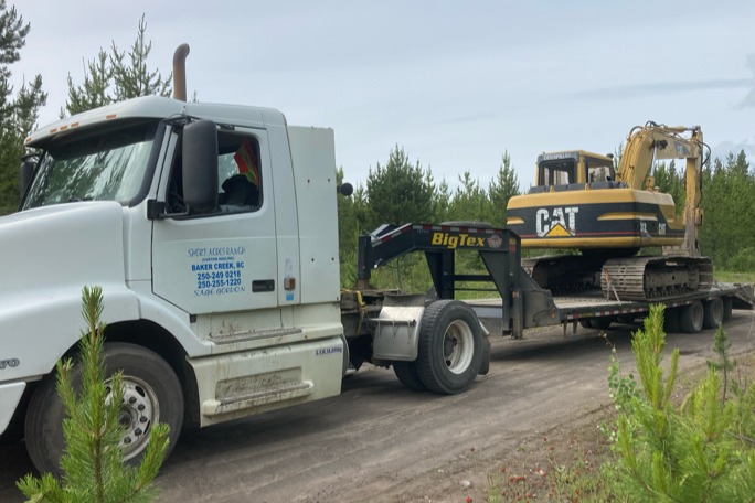 Short Acres Trucking truck hauling excavator